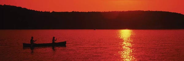 Canoes: Tourists canoeing in a lake at sunset, Oquaga Lake, Deposit, Broome County, New York State, USA by Panoramic Images
