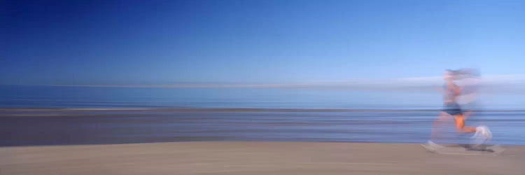 Blurred Motion Side Profile Of A Woman Running On The Beach