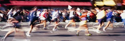 Blurred Motion Side Profile Of Marathon Runners by Panoramic Images framed canvas print