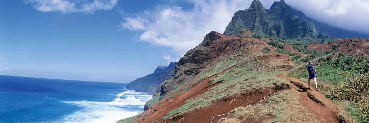 Adult hiking up a mountain, Kalalau Trail , Na Pali Coast, Kauai, Hawaiis