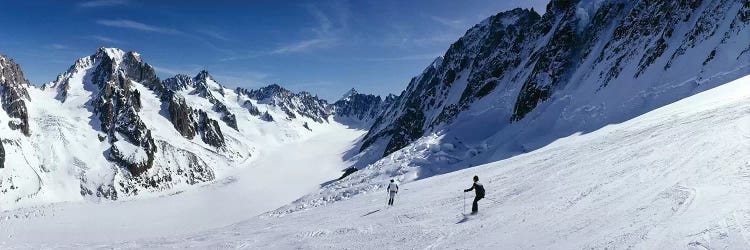 Rear view of two people skiing, Les Grands Montets, Chamonix, France