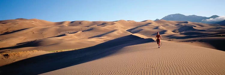 Close up of Woman running in the desert, Great Sand Dunes National Monument, Colorado, USA