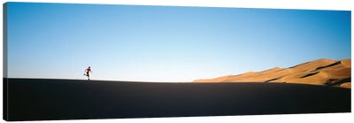 Low angle view of a woman running in the desert 2, Great Sand Dunes National Monument, Colorado, USA Canvas Art Print - Desert Landscape Photography