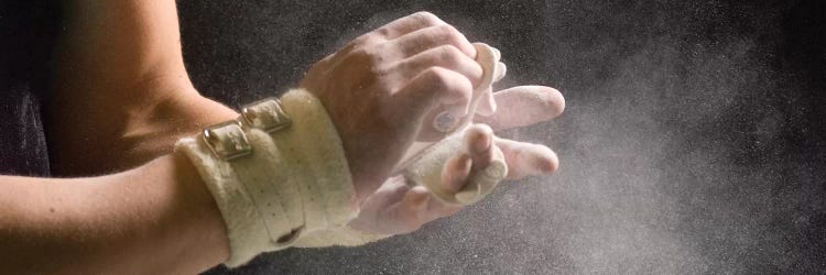 Male gymnast putting chalk on his hands 5, Bainbridge Island, Washington State, USA