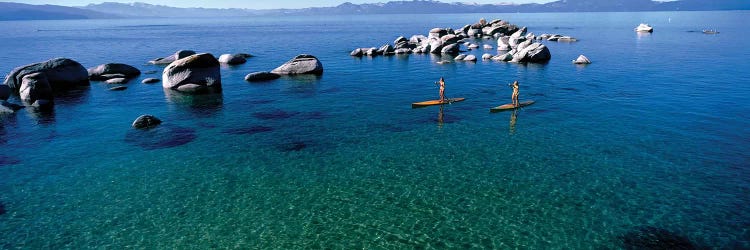 Two women paddle boarding in a lake 2, Lake Tahoe, California, USA