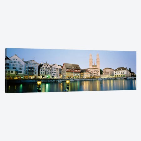 Riverfront Architecture At Twilight Featuring Grossmunster, Limmat River, Zurich, Switzerland Canvas Print #PIM129} by Panoramic Images Art Print