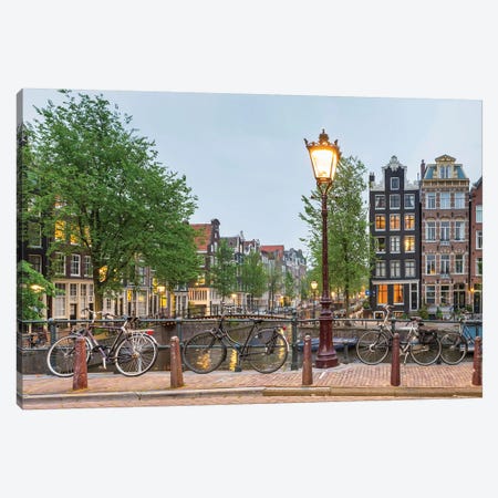Bikes And Houses Along Canal At Dusk, Amsterdam, North Holland Canvas Print #PIM14289} by Panoramic Images Canvas Print