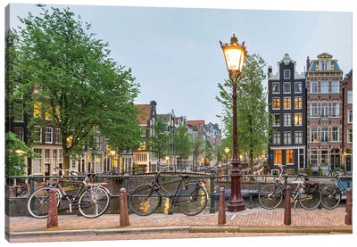 Bikes And Houses Along Canal At Dusk, Amsterdam, North Holland Canvas Art Print