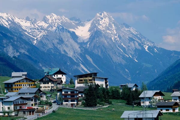 Austria: High angle view of a village on a landscape and a mountain range in the background, St. Anton, Austria by Panoramic Images