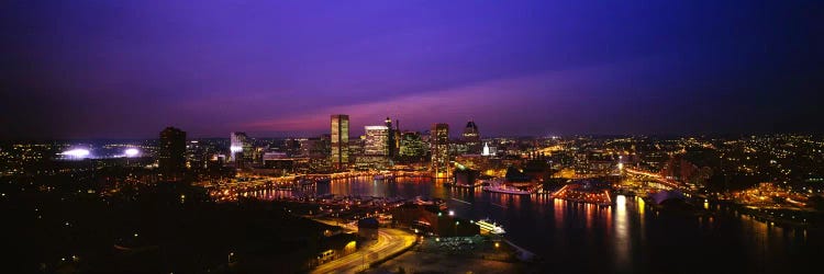 Aerial view of a city lit up at duskBaltimore, Maryland, USA