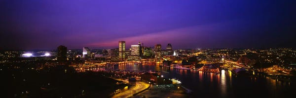 Aerial view of a city lit up at duskBaltimore, Maryland, USA