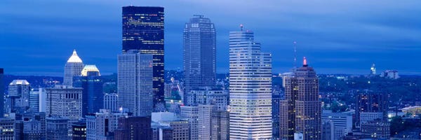 Pittsburgh Skylines: High angle view of skyscrapers lit up at duskPittsburgh, Pennsylvania, USA by Panoramic Images