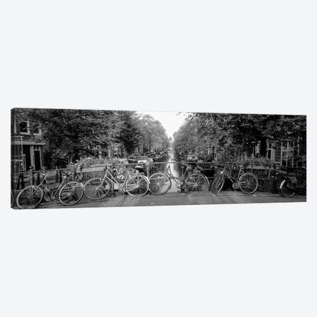 Bicycles On Bridge Over Canal, Amsterdam, Netherlands Canvas Print #PIM15083} by Panoramic Images Canvas Artwork