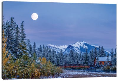 Moon over Pigeon Mountain and log cabin in forest and bridge near Policemans Creek, Canmore, Alberta, Canada Canvas Art Print - Cabins