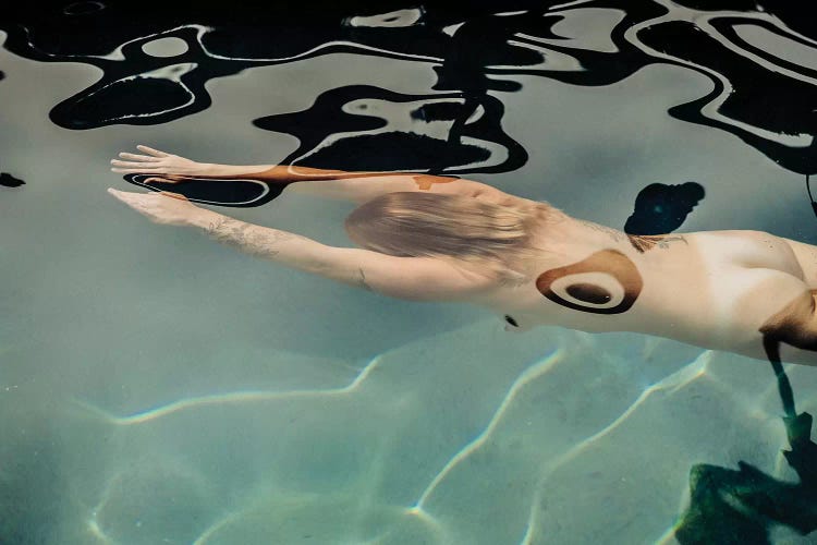 Naked woman diving in swimming pool