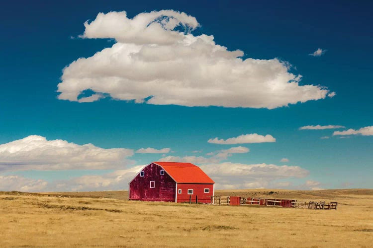 Oklahoma, USA Red barn in field with puffy clouds in remote Oklahoma