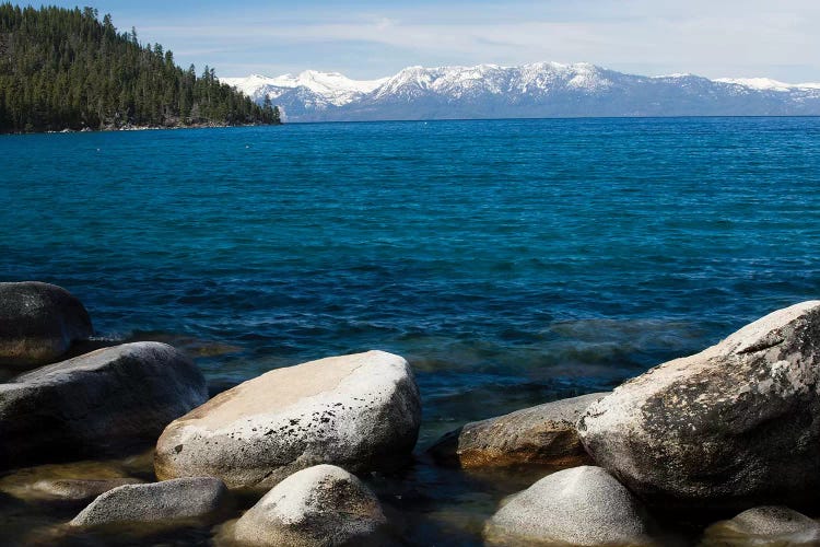 Rocks in a lake with mountain range in the background, Lake Tahoe, California, USA