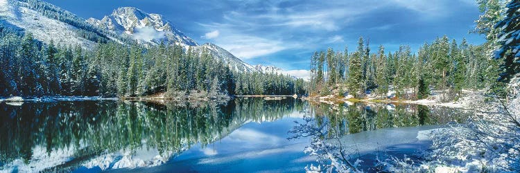 Snow covered mountain and trees reflected in lake, Grand Tetons, Wyoming, USA