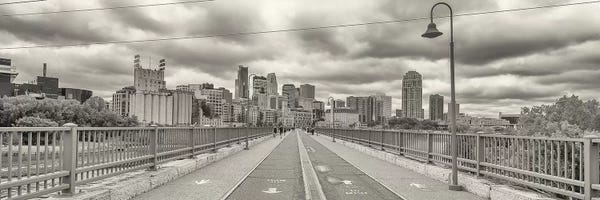 Minnesota: Stone Arch Bridge with buildings in the background, Mill District, Upper Midwest, Minneapolis, Hennepin County, Minnesota, USA by Panoramic Images