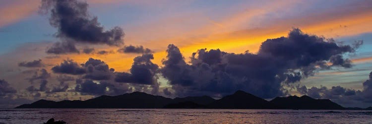 Silhouetted Fishing Boat In Sea At Sunset With Praslin Island In Background, La Digue, Seychelles