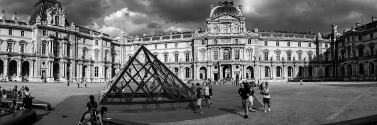 Tourists Near A Glass Pyramid At Musee Du Louvre, Paris, France