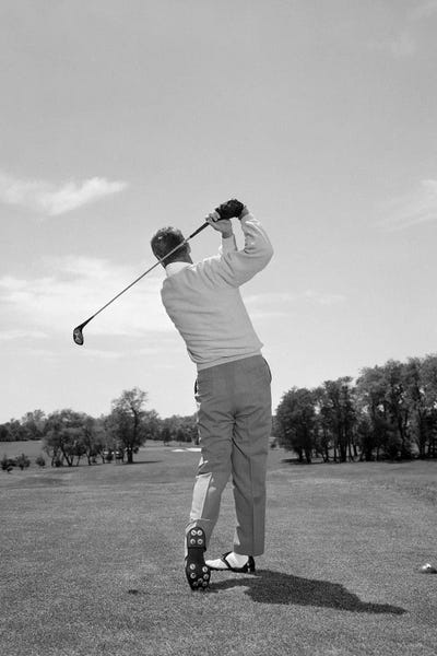 Athletes: 1950s 1960s Rear View Man Swinging Golf Club by Panoramic Images