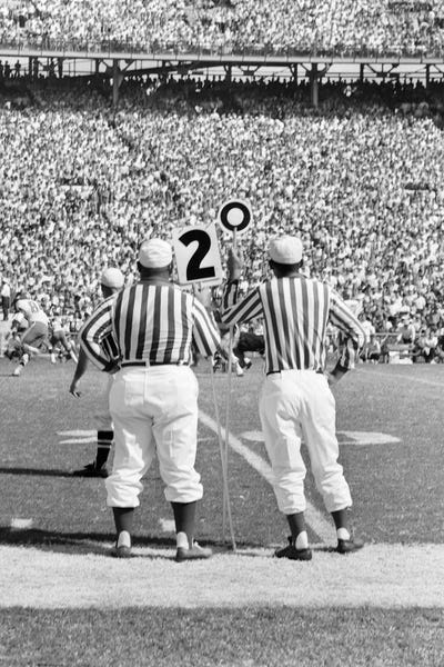 1960s Professional Football Game From Sidelines Referees Crowded Stadium
