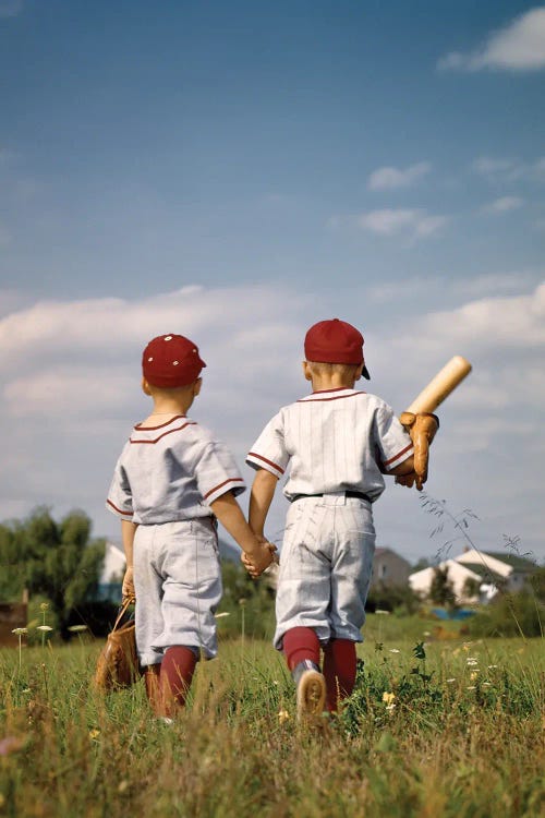 1960s Two Boys Brothers Wearing Little League Baseball Uniforms Holding Hands