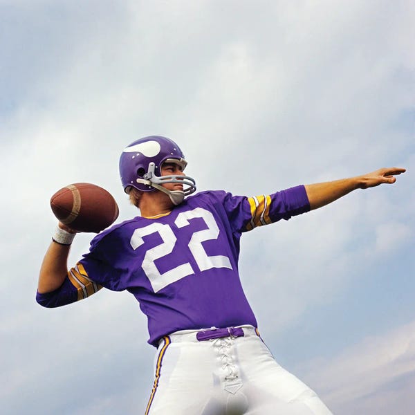 Athletes & Coaches: 1970s Football Player In Purple Jersey And Helmet About To Throw A Pass by Panoramic Images