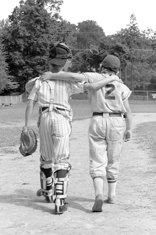 1970s Back View Of Pair Of Little Leaguers Walking Off Of Field With Arms Around Each Other