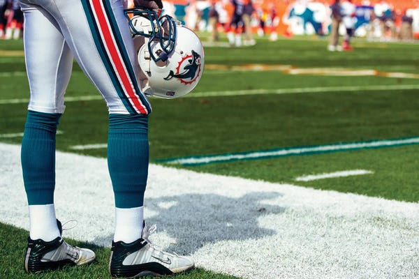 Athletes: Player Holding Helmet, Horizontal, Pro Player, Dolphins Vs Bills, 12/05/2004 by Panoramic Images