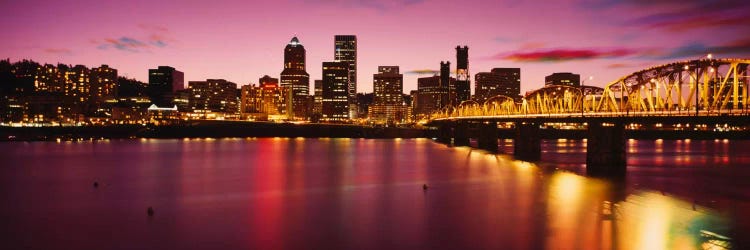 Skyscrapers lit up at sunset, Willamette River, Portland, Oregon, USA