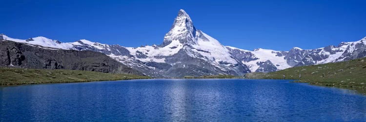 A Snow Covered Matterhorn With Reffelsee In The Foreground, Valais, Switzerland