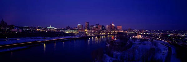 Minnesota: Reflection of buildings in a river at nightMississippi River, Minneapolis & St Paul, Minnesota, USA by Panoramic Images