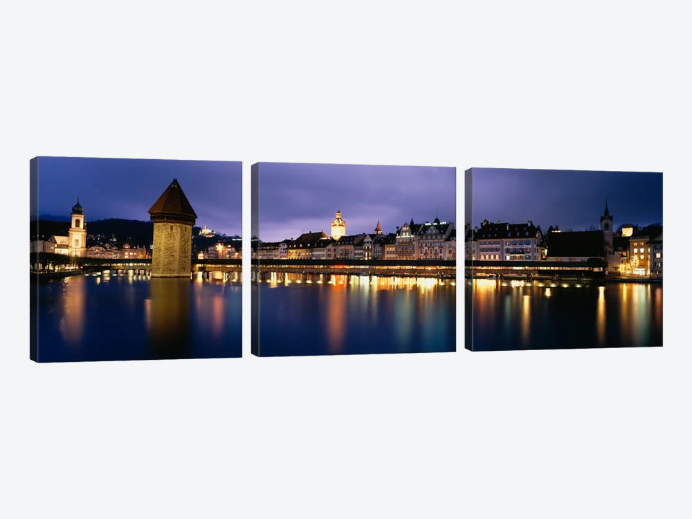 Buildings lit up at dusk, Chapel Bridge, Reuss River, Lucerne, Switzerland by Panoramic Images 3-piece Canvas Print