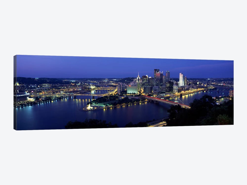Buildings along a river lit up at dusk, Monongahela River, Pittsburgh, Allegheny County, Pennsylvania, USA by Panoramic Images 1-piece Canvas Art Print
