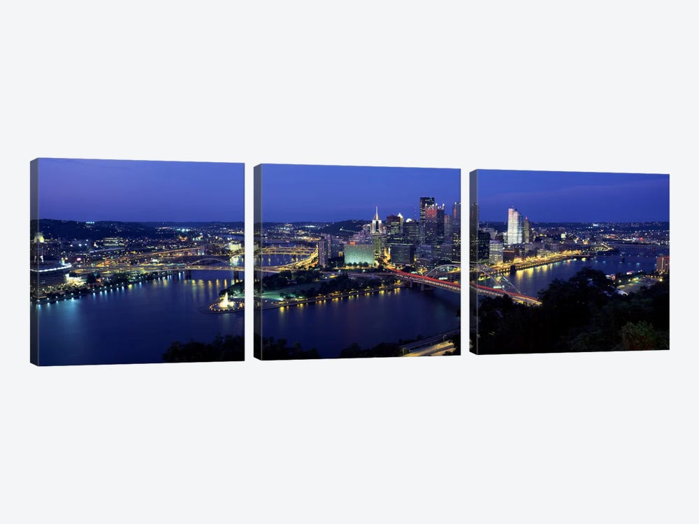 Buildings along a river lit up at dusk, Monongahela River, Pittsburgh, Allegheny County, Pennsylvania, USA by Panoramic Images 3-piece Canvas Print
