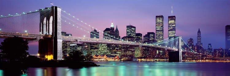 An Illuminated Brooklyn Bridge With Lower Manhattan's Financial District Skyline In The Background, New York City, New York 