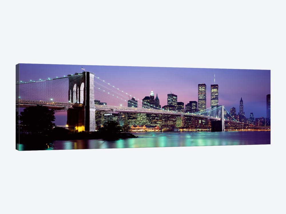 An Illuminated Brooklyn Bridge With Lower Manhattan's Financial District Skyline In The Background, New York City, New York  by Panoramic Images 1-piece Canvas Print