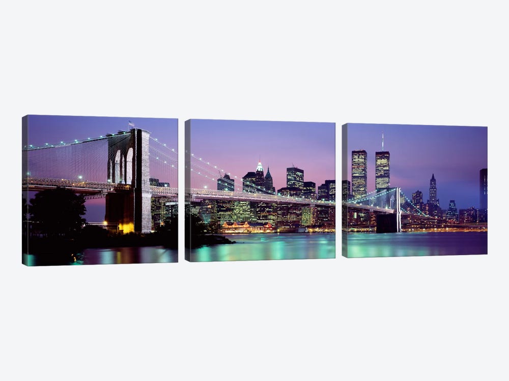 An Illuminated Brooklyn Bridge With Lower Manhattan's Financial District Skyline In The Background, New York City, New York  by Panoramic Images 3-piece Canvas Art Print