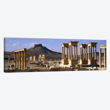 The Tetrapylon Of The Great Colonnade With A Distant View Of Fakhr-al-Din al-Ma'ani Castle, Palmyra, Homs Governorate, Syria Canvas Print #PIM2530} by Panoramic Images Canvas Print