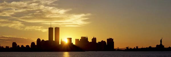 City Sunrises & Sunsets: Manhattan skyline & a statue at sunrise Statue of Liberty, New York City, New York State, USA by Panoramic Images