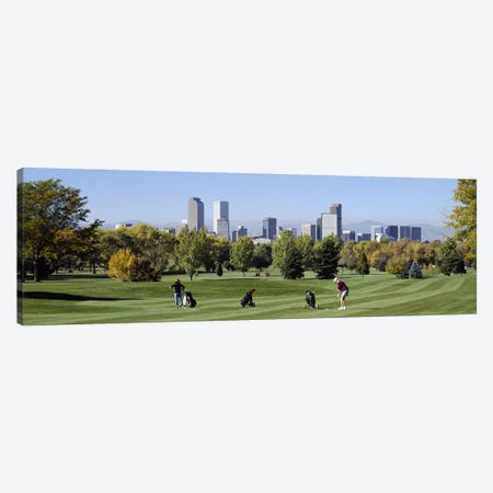 Four people playing golf with buildings in the background, Denver, Colorado, USA Canvas Print #PIM2704} by Panoramic Images Canvas Art Print