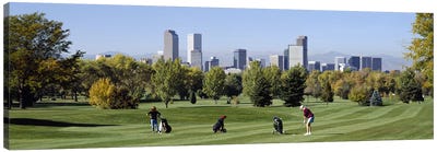 Four people playing golf with buildings in the background, Denver, Colorado, USA Canvas Art Print