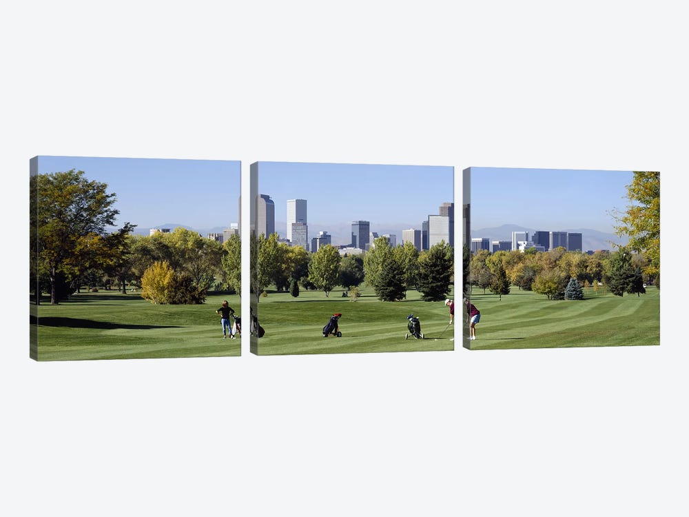 Four people playing golf with buildings in the background, Denver, Colorado, USA by Panoramic Images 3-piece Art Print