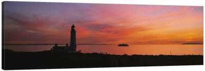 Silhouette of a lighthouse at sunset, Scotland Canvas Art Print - Lake & Ocean Sunrise & Sunset Art