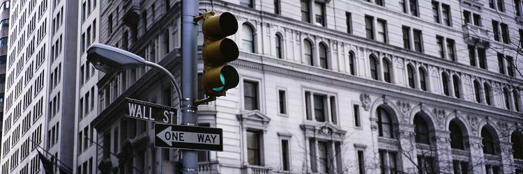 Low angle view of a traffic light in front of a buildingWall Street, New York City, New York State, USA