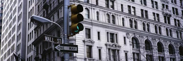 Manhattan: Low angle view of a traffic light in front of a buildingWall Street, New York City, New York State, USA by Panoramic Images