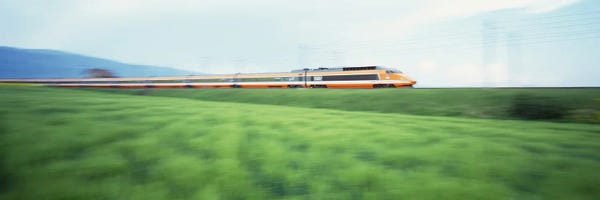 Trains: TGV High-speed Train passing through a grassland by Panoramic Images