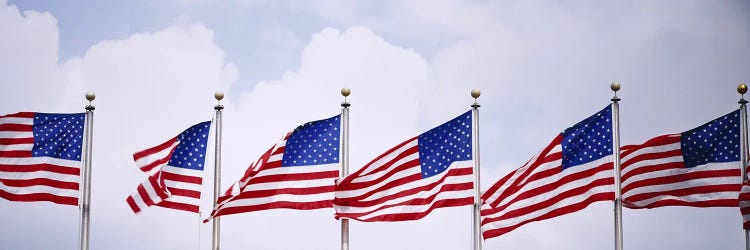 Low angle view of American flags fluttering in wind